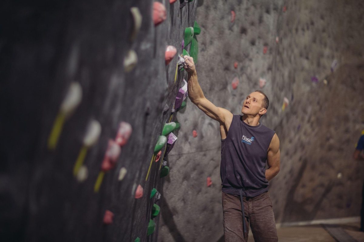 Dan Poggi inspecting holds at ClimbBase5